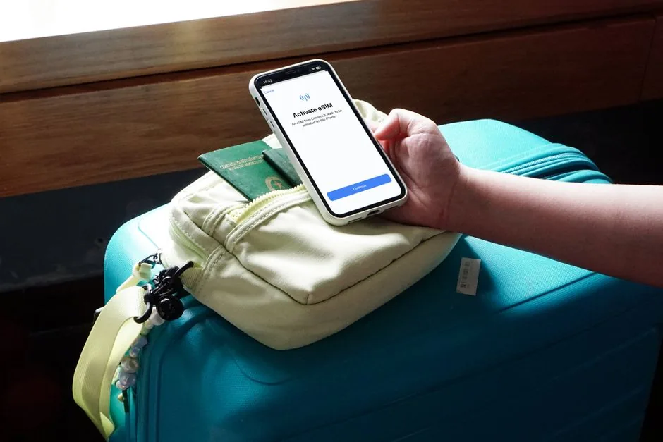 Traveler choosing between hard-shell and soft-sided suitcases